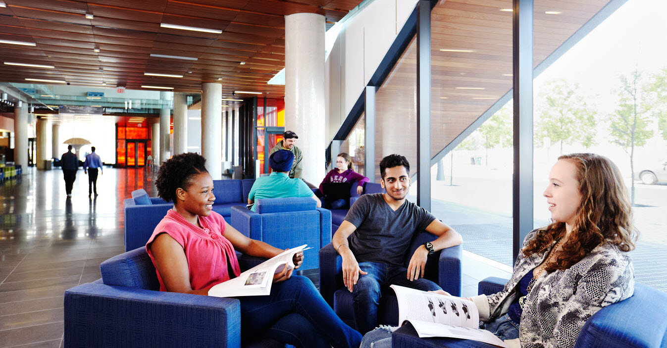 George Brown College students relax while waiting with WaitWell queue management solution